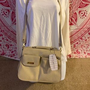 NWT Ivory crossbody purse. Many storage pockets.